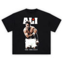 Ali Red Star tee with roaring Muhammad Ali pose, bold white block letters, red star accent, and “The Greatest” caption