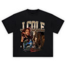 J Cole Dreamville T-Shirt featuring a collage of Cole performing, in profile, and sitting on a rooftop, with bold text and Dreamville logo.