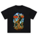 Angela Goes to Camp Horror Comedy T-Shirt featuring smiling killer with chainsaw, terrified campers, forest setting, and dark humor elements