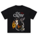 The Crow It Cant Rain All the Time Graphic T Shirt featuring Eric Draven with a bleeding hand, gothic imagery, crow, cityscape, and white roses
