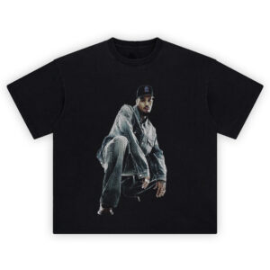 Chris Brown Shirt showing crouched denim pose with cap on black halftone background