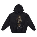 Anthony Edwards Big Face Hoodie graphic showing a warm-lit close-up portrait with a stud earring, bright chain necklace with lettered pendant, and signature detail on a black hoodie.