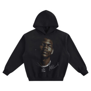 Anthony Edwards Big Face Hoodie graphic showing a warm-lit close-up portrait with a stud earring, bright chain necklace with lettered pendant, and signature detail on a black hoodie.