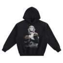 Shedeur Sanders Big Face Hoodie graphic showing Shedeur Sanders in a helmet with visor holding a football, with a script signature detail on a black hoodie.