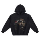 Hakeem Olajuwon Big Face Hoodie graphic showing a close-up portrait of Hakeem Olajuwon wearing oversized clear goggles with a red strap detail and a small signature-style mark on a black hoodie.