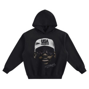 LeBron James Big Face Hoodie graphic showing a close-up portrait of LeBron James wearing dark shades and a white USA Basketball cap with a signature-style mark on a black hoodie.