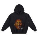 Kobe Bryant Smile Big Face Hoodie graphic showing a close-up smiling portrait of Kobe Bryant with an afro silhouette outline and a signature-style mark on a black hoodie.