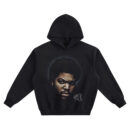 Ice Cube Big Face Hoodie graphic showing a close-up portrait with afro, intense expression, cool halo glow, and a signature mark on a black hoodie.