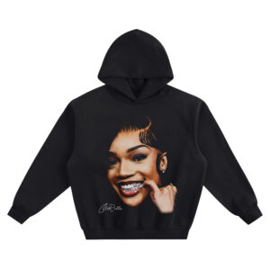 GloRilla Big Face Hoodie graphic showing a close-up smiling portrait with grill detail, finger at the cheek, side-swoop hair, stud earring, and “GloRilla” signature on a black hoodie.