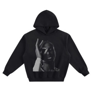 Shai Gilgeous-Alexander Big Face Hoodie graphic showing a black-and-white close-up portrait with an “OK” hand circle over one eye and “Shai Gilgeous Alexander” signature on a black hoodie.