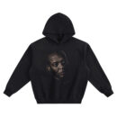 Dr. Dre Big Face Hoodie graphic showing a close-up portrait with a side gaze, bald head, stud earring detail, and shadowed lighting on a black hoodie.