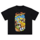 DuckTales Graphic Tee graphic showing “Disney’s DuckTales” title above Scrooge McDuck swinging on a rope with a yellow plane and character crew leaning from the windows.