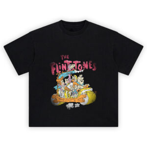 The Flintstones Graphic Tee graphic showing pink “THE FLINTSTONES” title above a crowded stone-age car scene with multiple cartoon characters riding together and dust puffs below on a black tee.