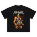 He-Man Graphic Tee graphic showing the “HE-MAN” title above He-Man holding a sword, wearing a blue chest harness with red emblem, gold belt, and red rocky background on a black t-shirt.